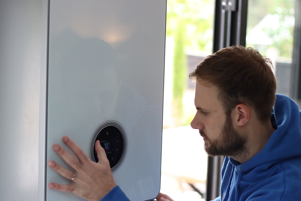 Caddo plumber dialing in a wall-hung water heater